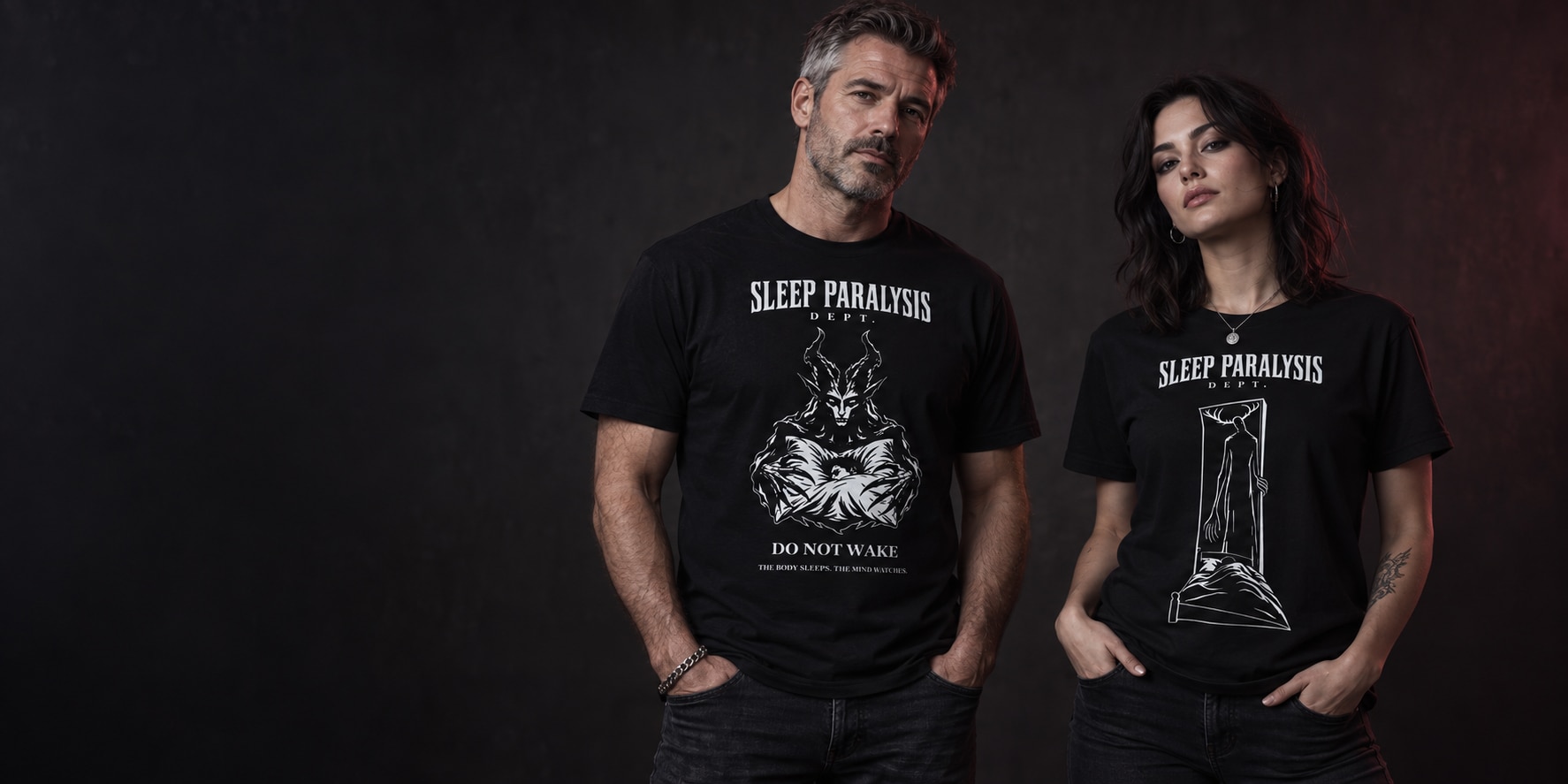 A man and woman wearing Do Not Wake and Doorway Watcher Sleep Paralysis Dept. shirts